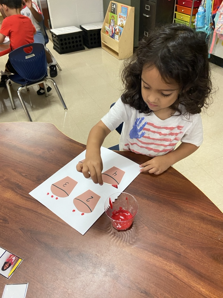 Kid doing an Apple activity.