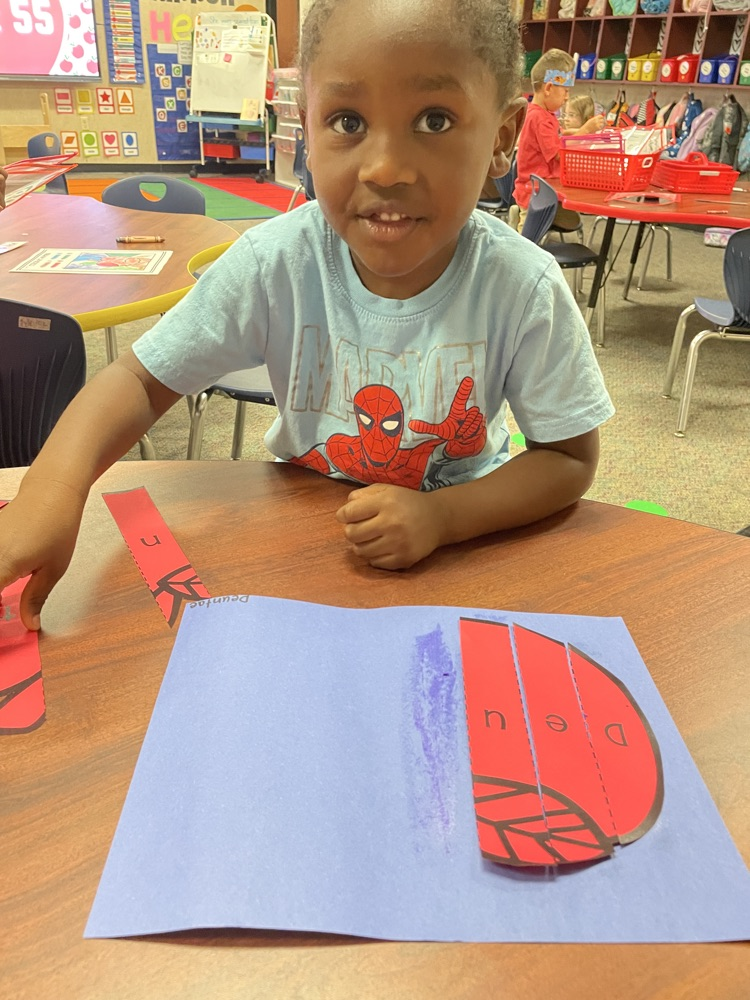 Kid doing an Apple activity.