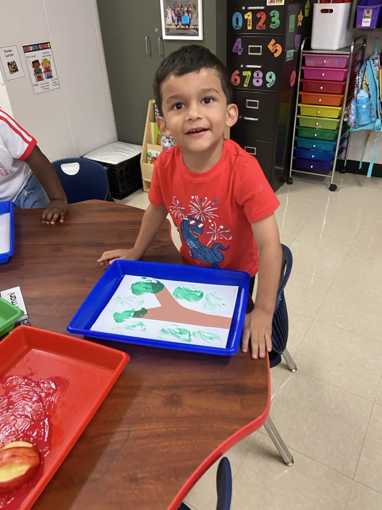 Kid doing an Apple activity.