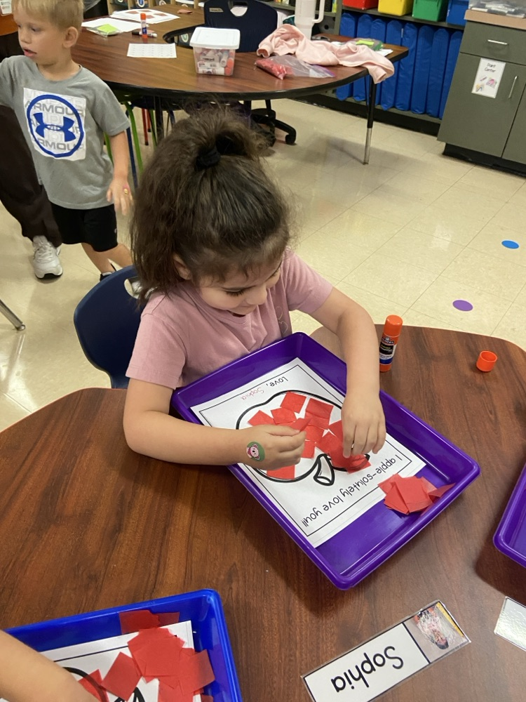 Kid doing an Apple activity.