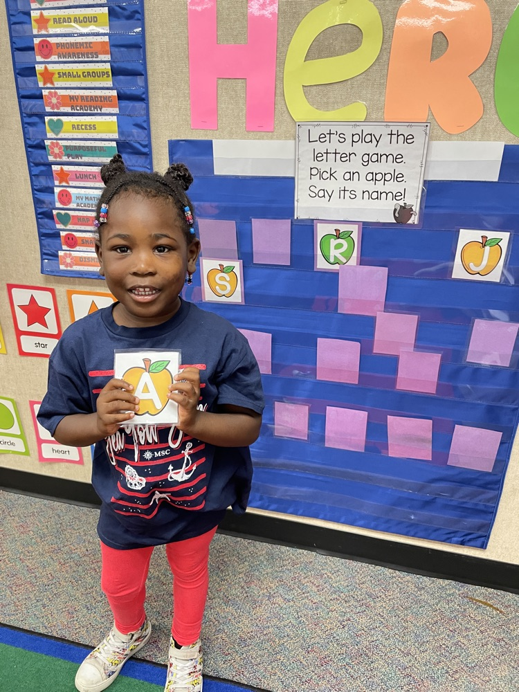 Kid doing an Apple activity.