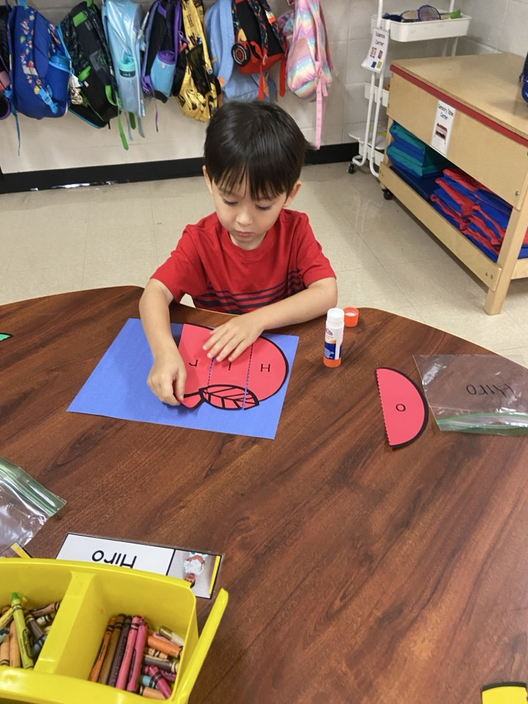 Kid doing an Apple activity.