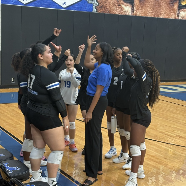 volleyball team in huddle