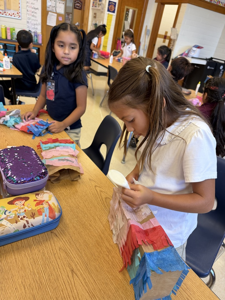 kid making a paper bag piñata 