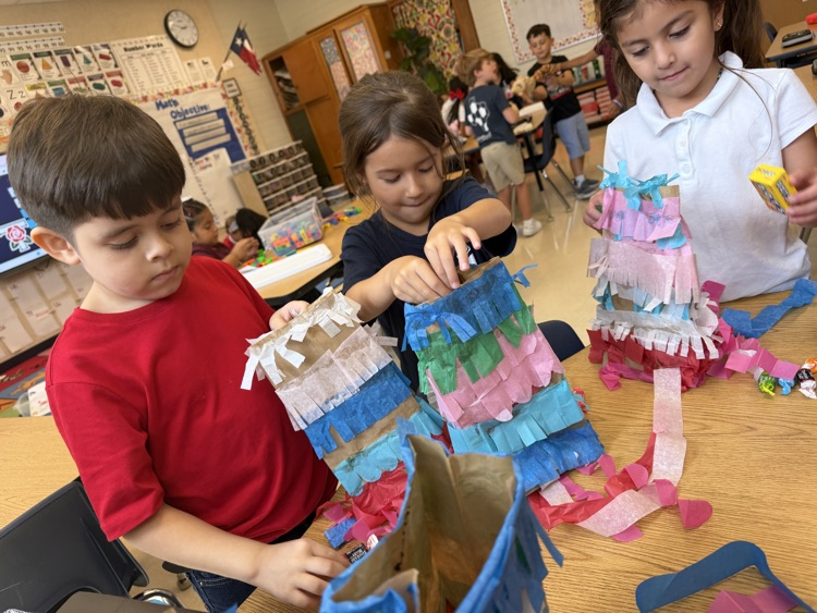 kid making a paper bag piñata 
