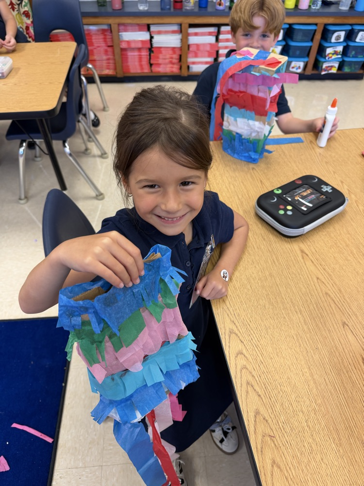 kid making a paper bag piñata 