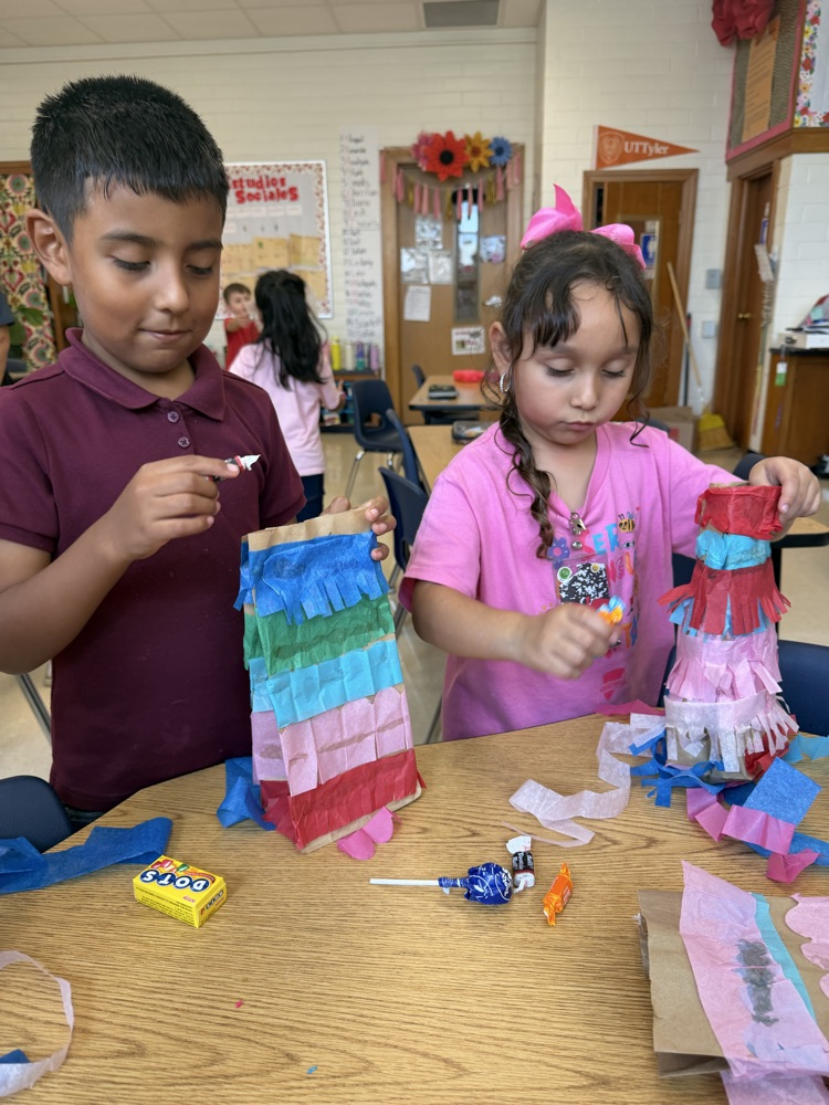 kid making a paper bag piñata 