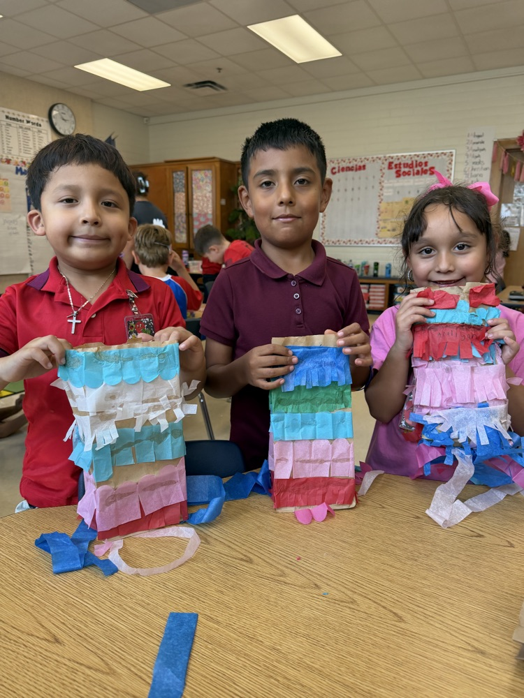 kid making a paper bag piñata 