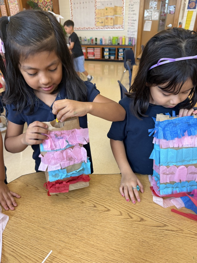 kid making a paper bag piñata 