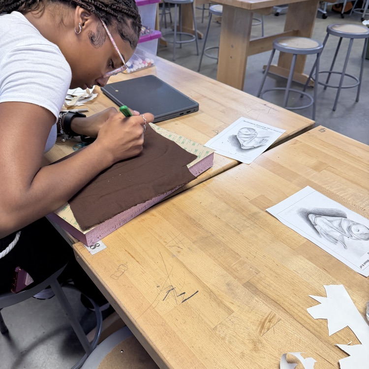 student working on art project