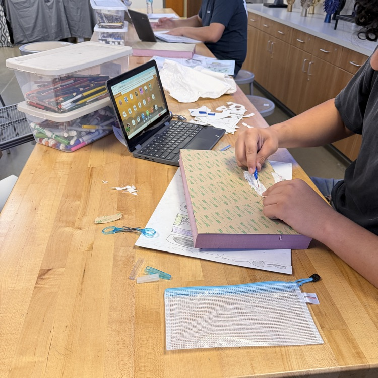 student working on art project