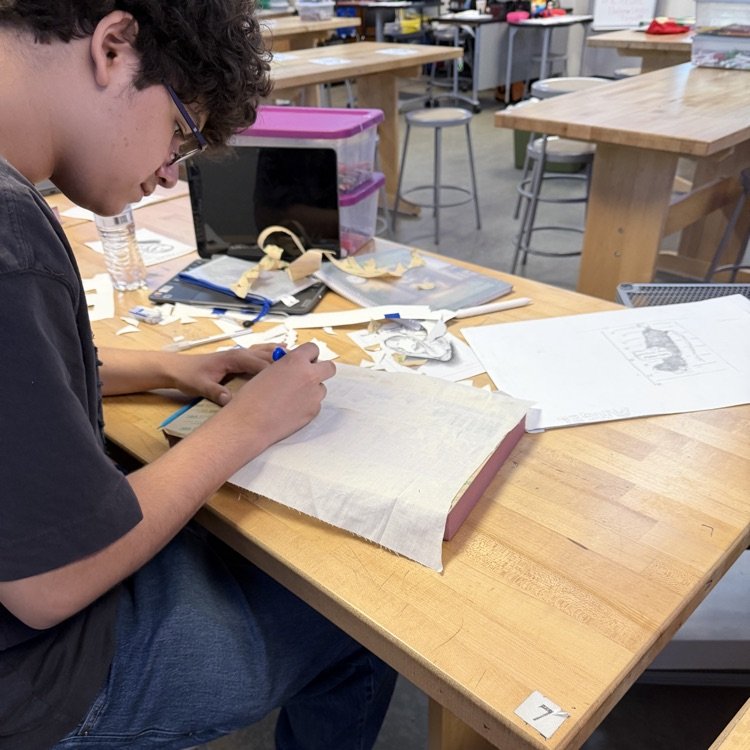 student working on art project