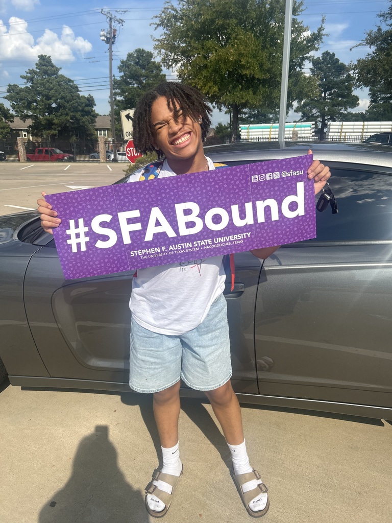 student holding banner showing college acceptance to SFA
