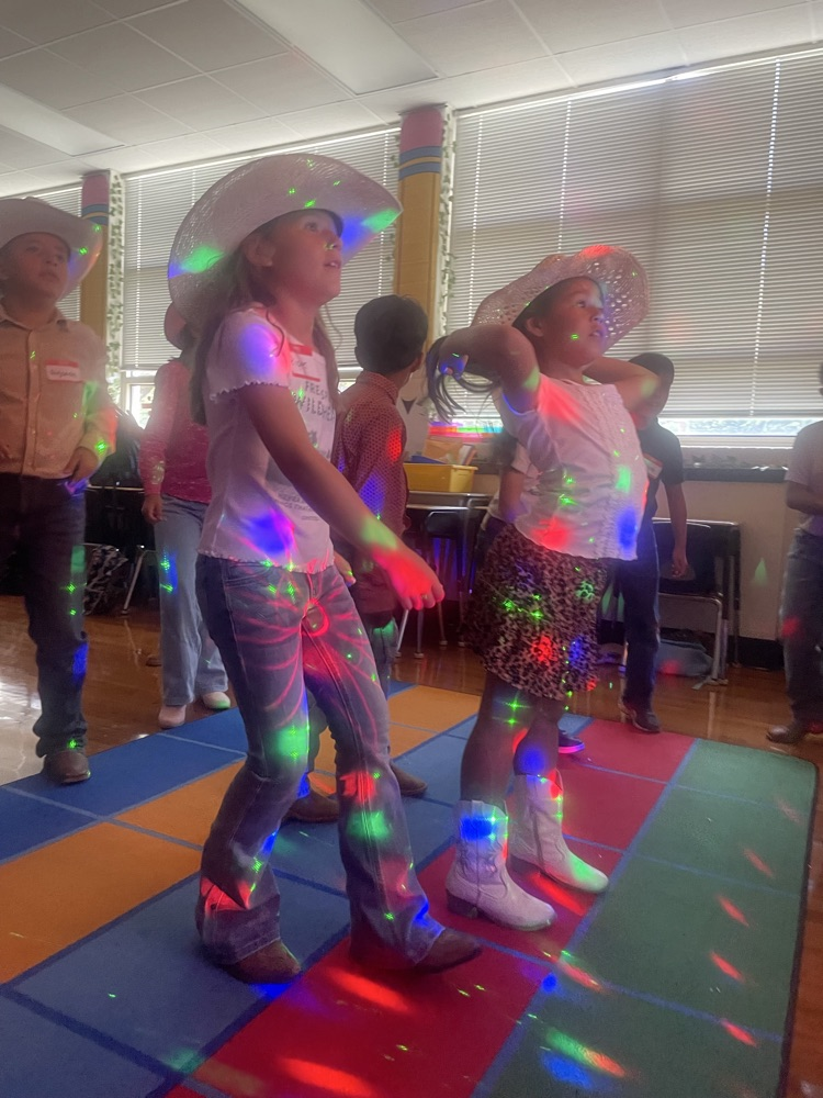 students dancing with colored lights