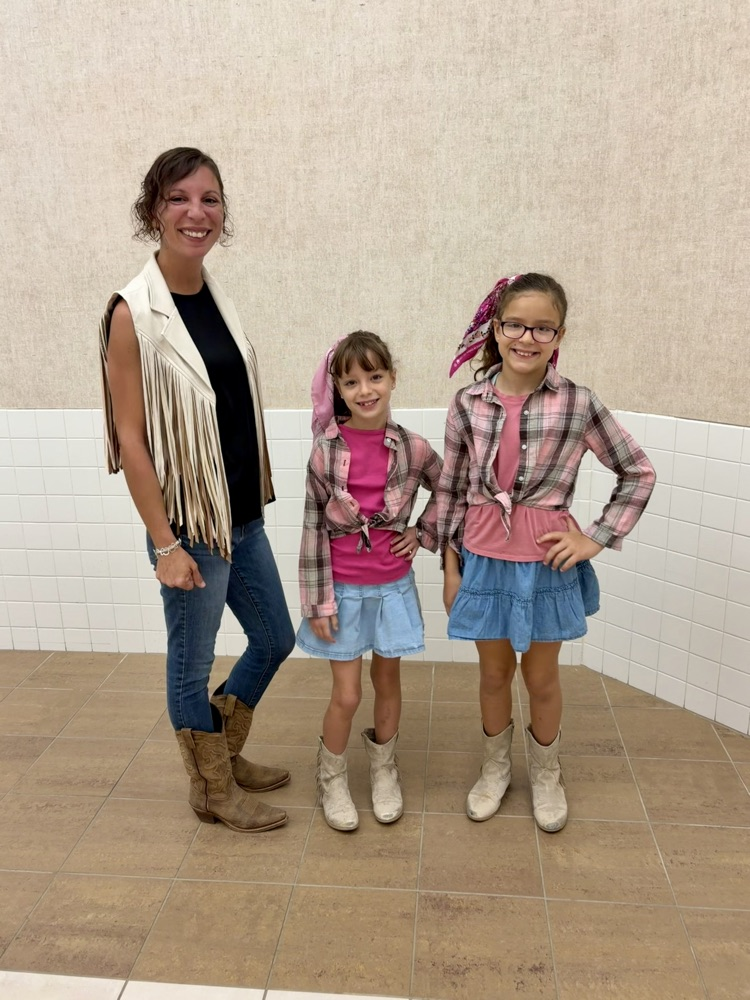 teacher and two girls in hallway