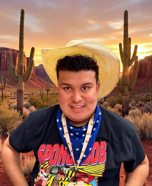 Student with western hat in front of a western scene