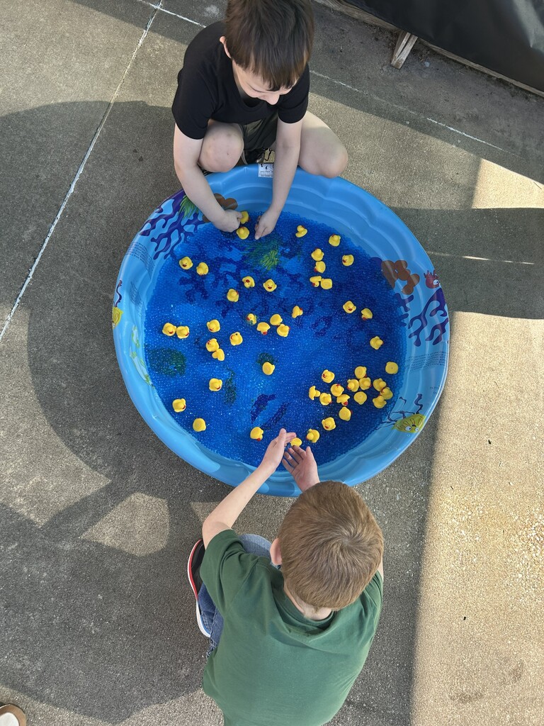 Two students playing the duck pond game.
