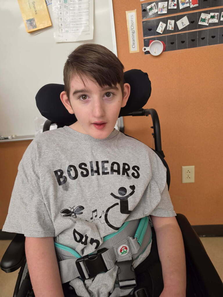 student in wheelchair with Boshears wheelchair dance team shirt on
