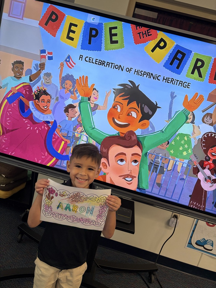 boy holding up paper