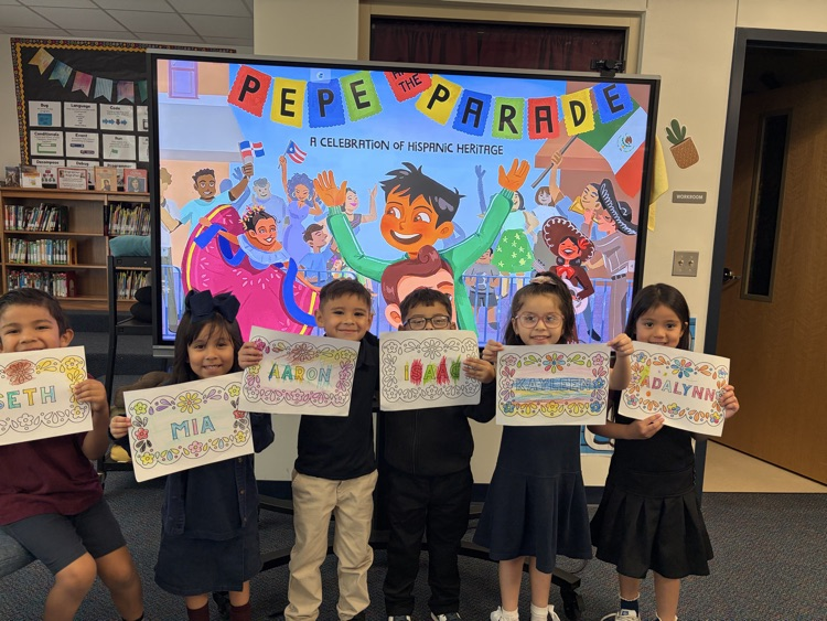 students holding up paper