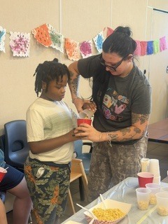 Student and teacher making elote