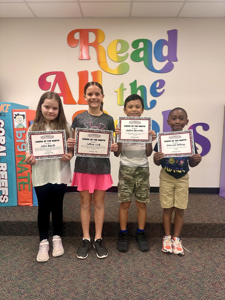 students holding certificates for leader of the month