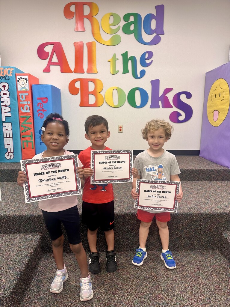 students holding certificates for leader of the month
