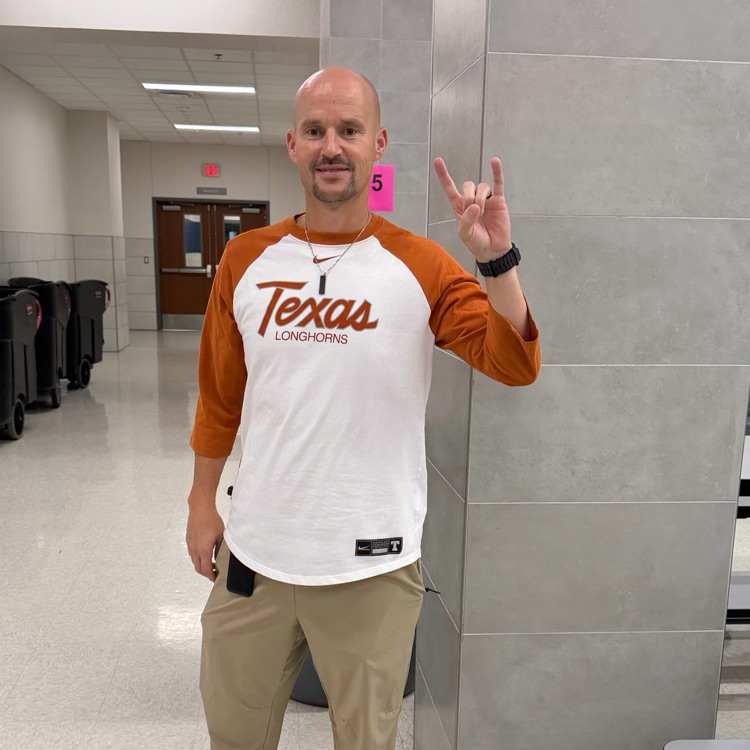 teacher wearing college shirt