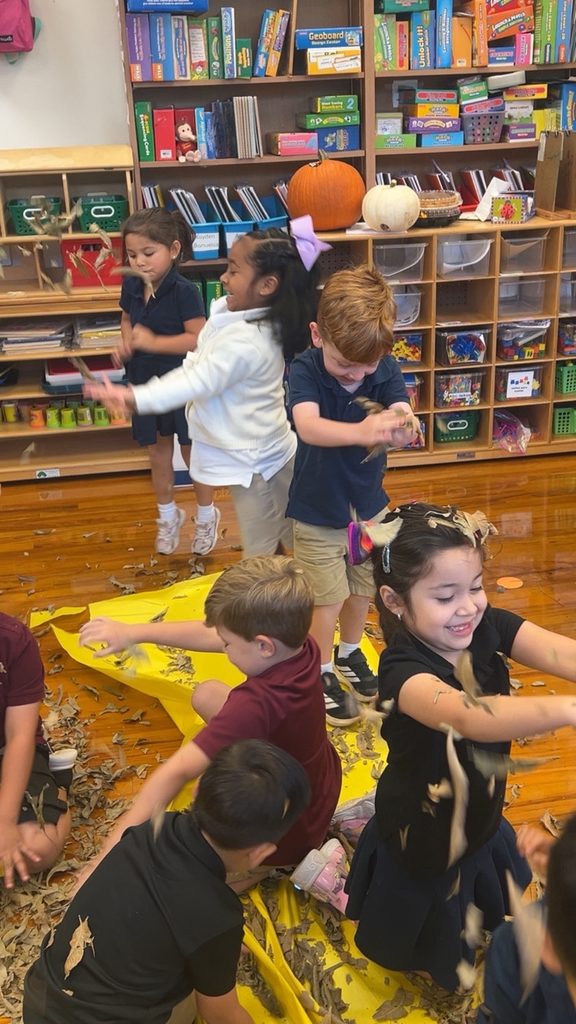 students playing in leaves