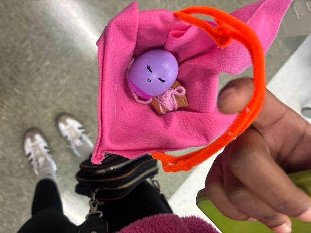 Student holding egg representing a baby in a basket