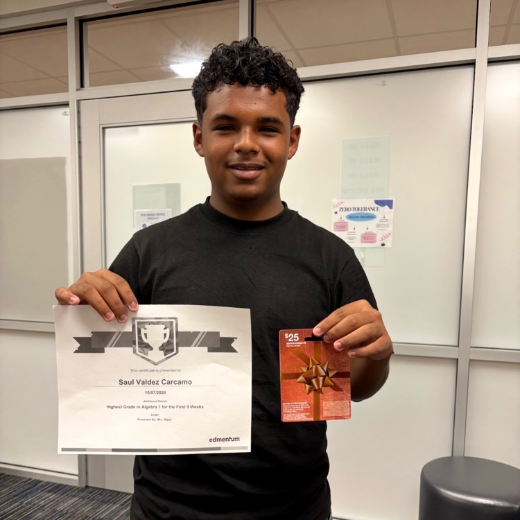 student holding a certificate and a gift card