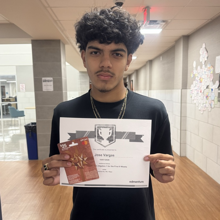 student holding a certificate and a gift card