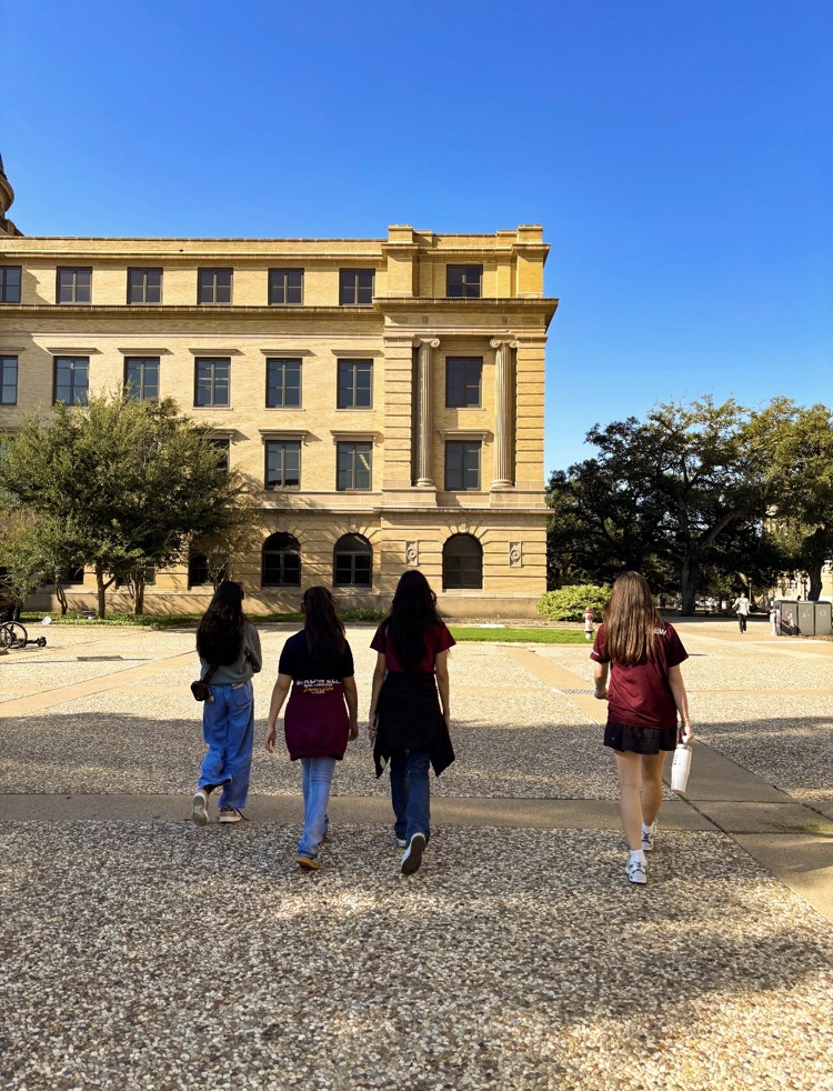 students on tour of A&M walking in front of building