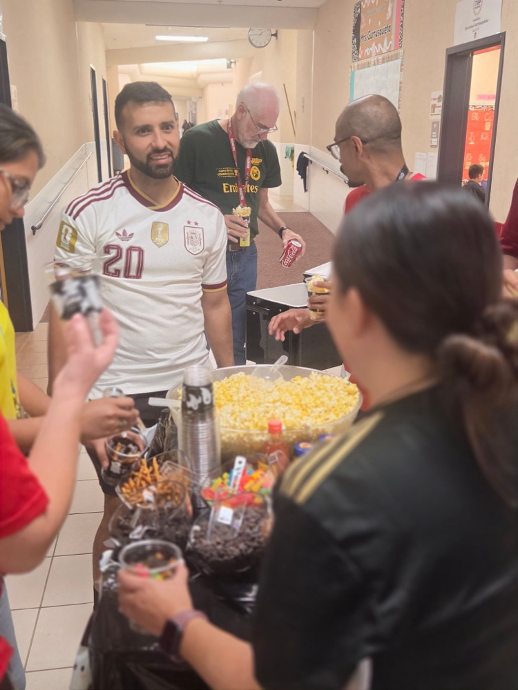teachers around cart getting popcorn