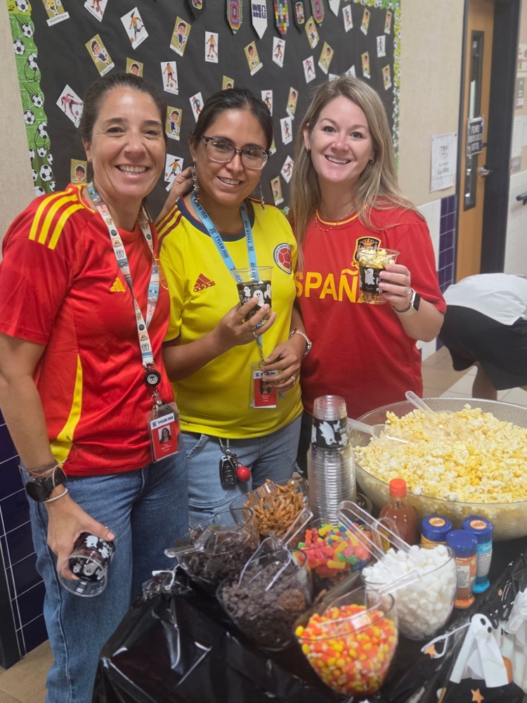 teachers standing beside popcorn cart