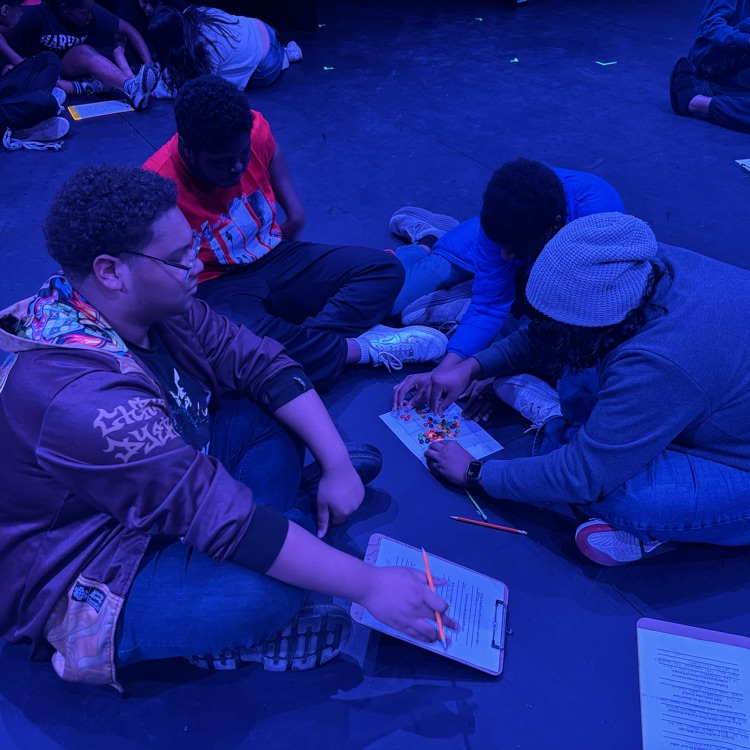 students sorting candy in blue light