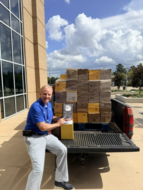 man with loads of composition books in his truck
