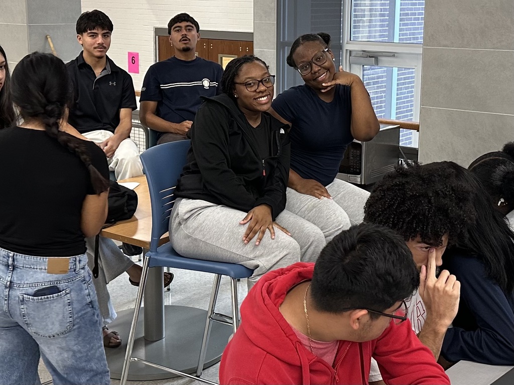 students sitting in chair posing for picture