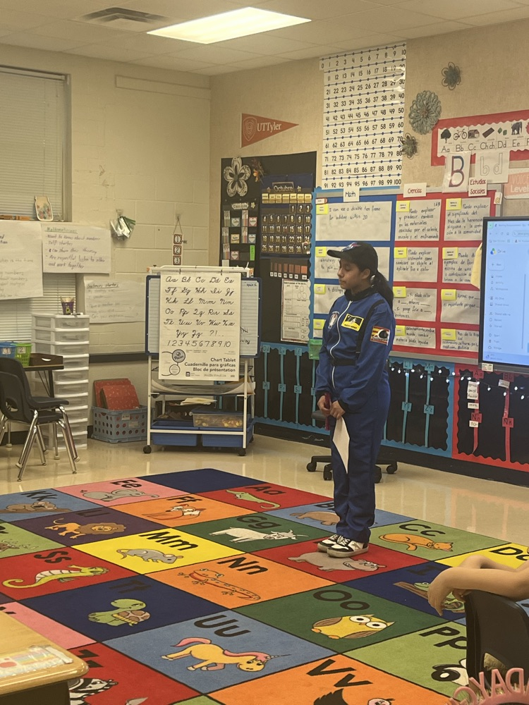 student dressed up as HHM character talking to elementary students