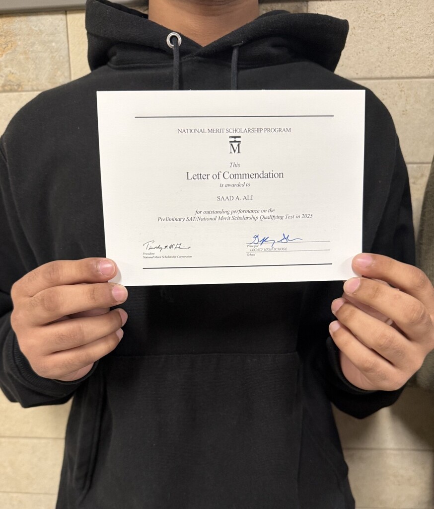 A person in a black hoodie holding a certificate titled "Letter of Commendation" from a program.