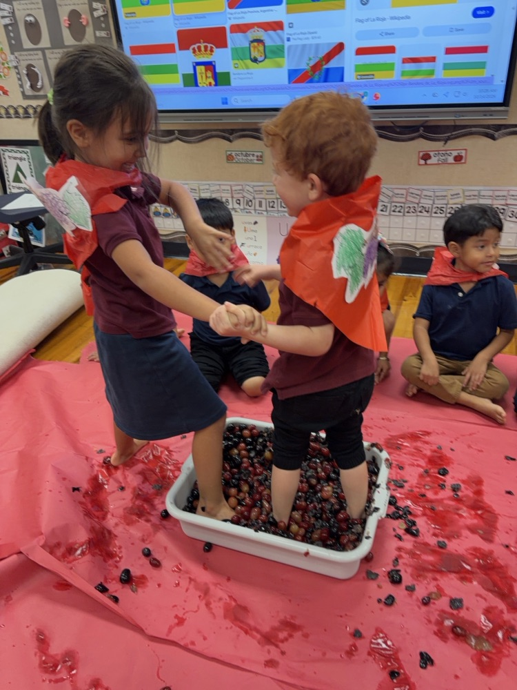 two kids stomping on grapes