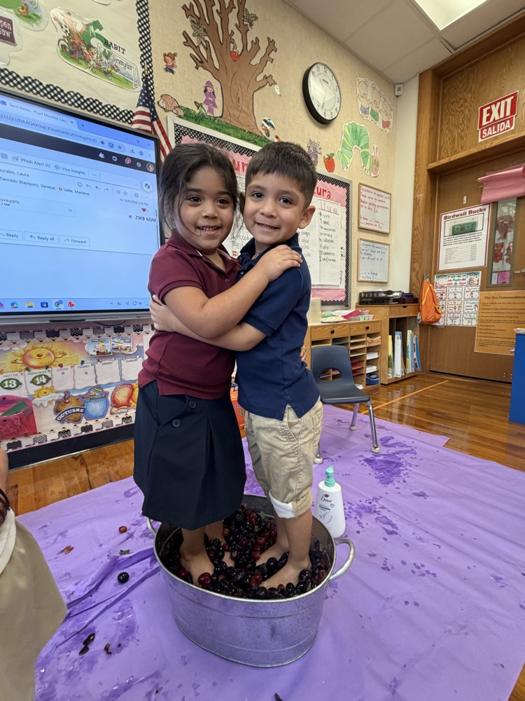 two kids stepping on grapes