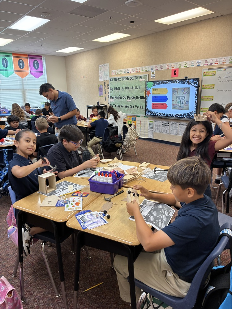 students at desk doing a science expert
