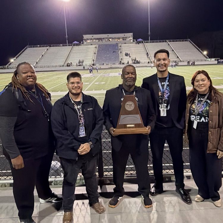 coaches holding trophy