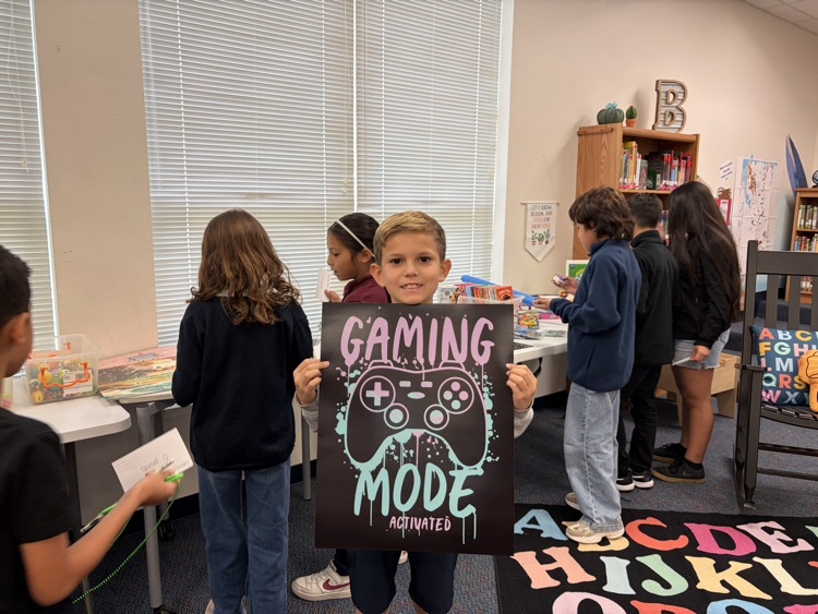 student holding up poster