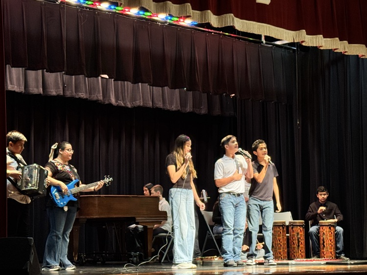 students on stage for music program