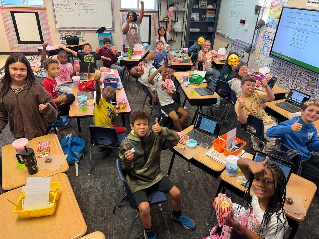 Kids celebrating and giving thumb's up.