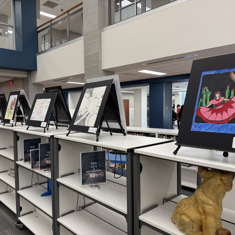 several art pieces on shelves