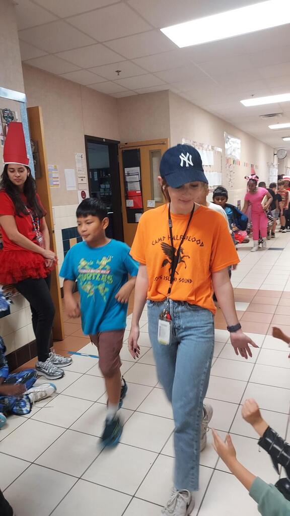. A person wears a hat and sneakers. 