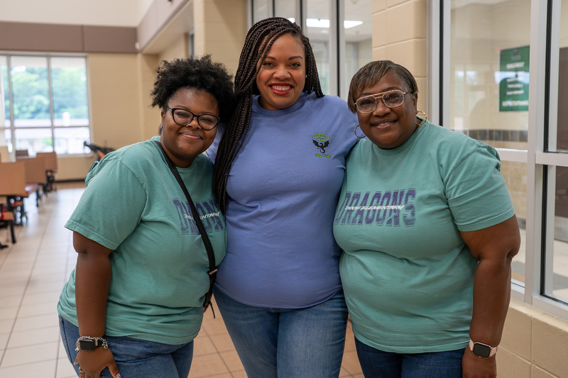 three women standing beside each other